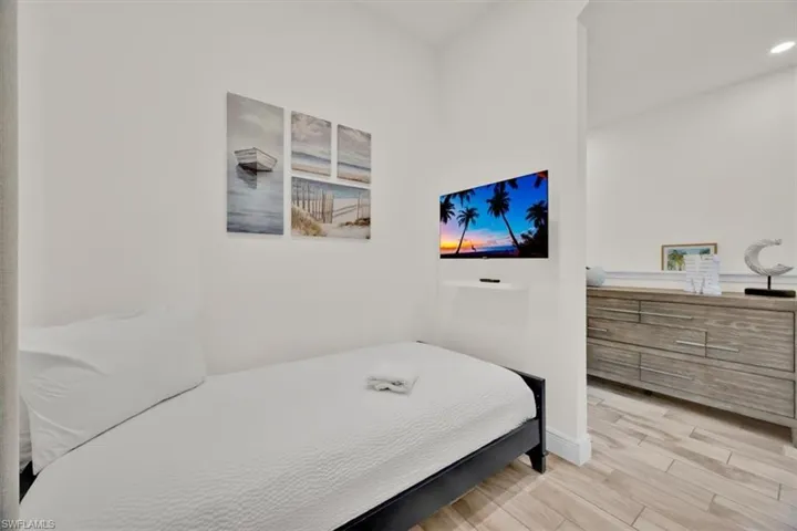 Bedroom featuring wood finished floors and baseboards