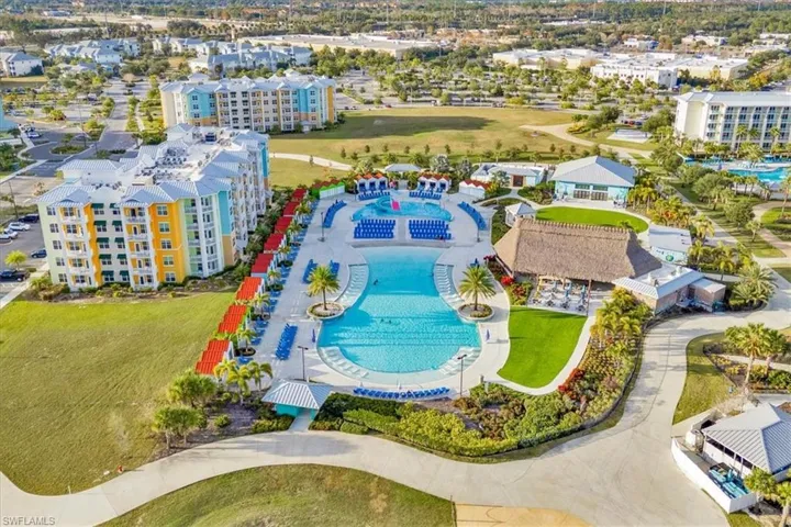 Drone / aerial view of a pool and apartment complex