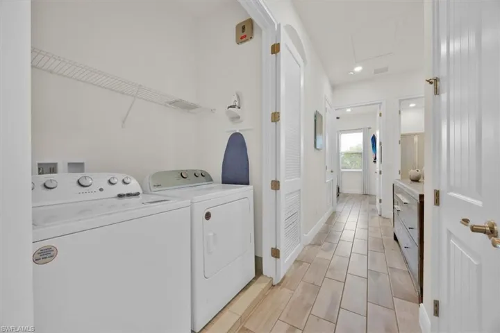 Laundry area featuring washer and dryer and recessed lighting