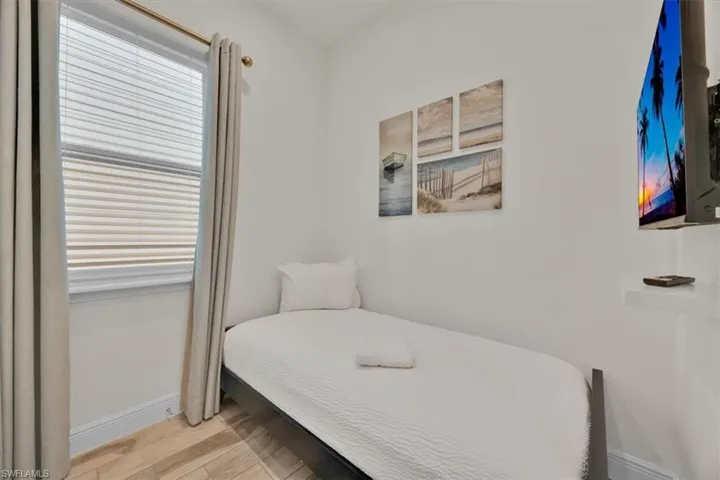 Bedroom with light wood finished floors and baseboards