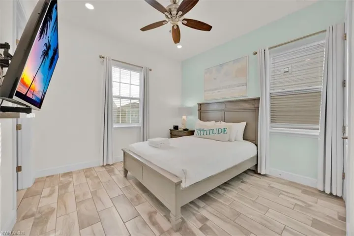 Bedroom featuring wood finish floors, ceiling fan, and recessed lighting