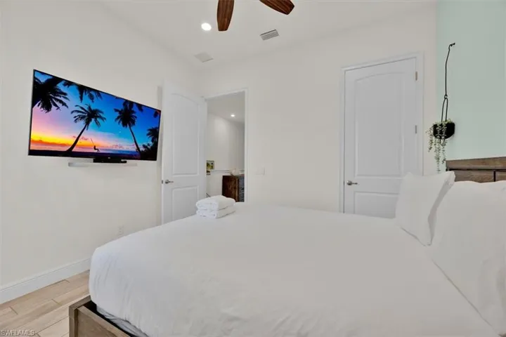 Bedroom with light wood-style floors, recessed lighting, and ceiling fan