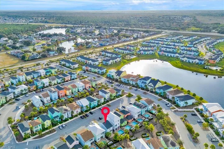 Aerial view of property's location featuring a large body of water and nearby suburban area