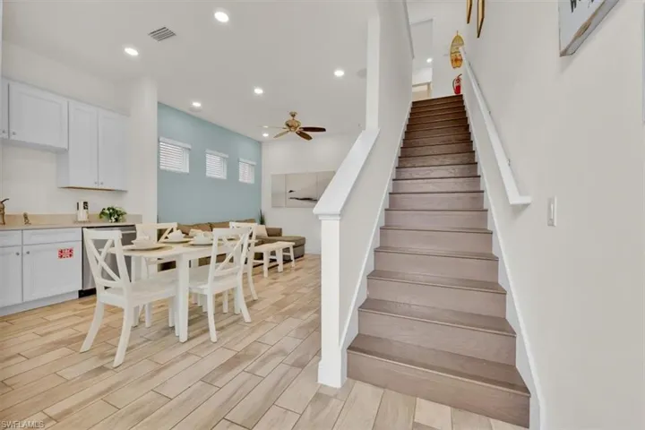 Staircase featuring wood finish floors, recessed lighting, and a ceiling fan