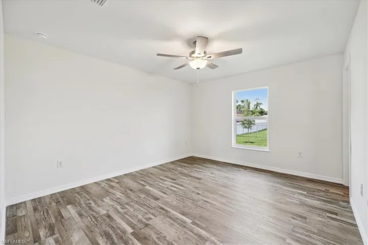 Empty room with light wood-type flooring and ceiling fan