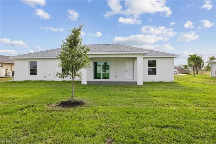 Rear view of property featuring a yard
