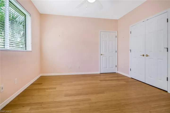 Second guest bedroom with bamboo flooring and a large closet.