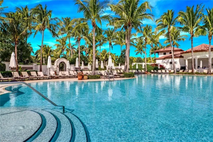 Another view of pool featuring a large lounging area for relaxing in the sun.