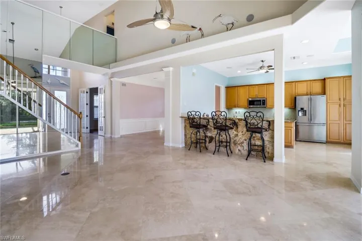 Kitchen with SS appliances, breakfast bar, pantry and an island.