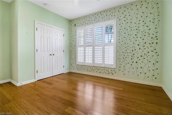One of two guest bedrooms with bamboo flooring and a large closet.  Nice and bright!