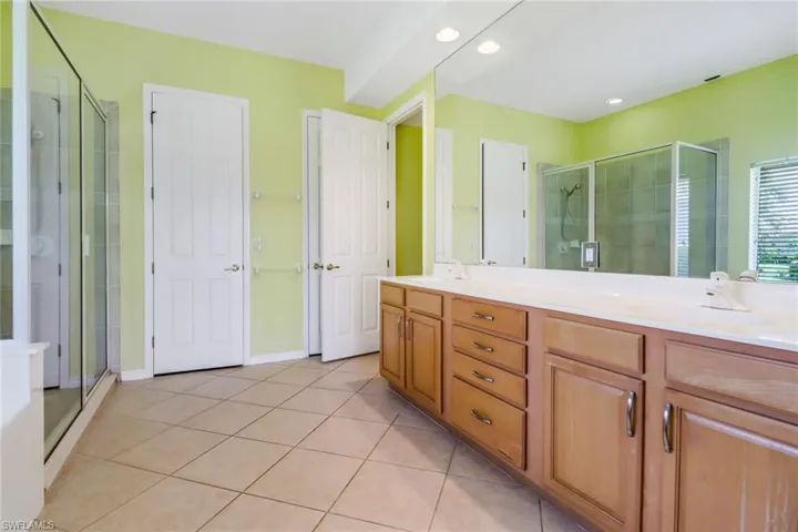 Primary bathroom with dual sinks, lots of storage, and separate water closet. Two large walk-in closets.