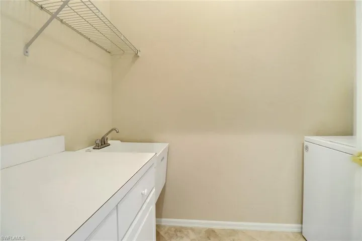 Laundry Room with cabinets, wash sink washer & dryer.