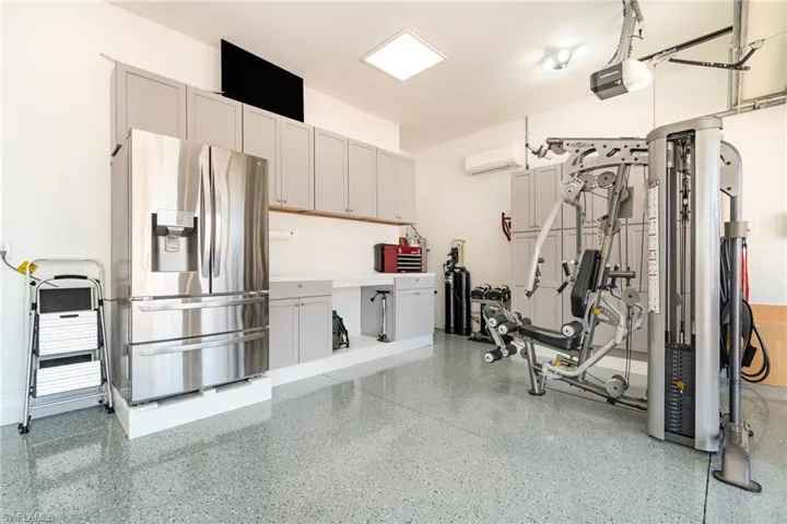 3 Car Garage with Epoxy Finished Floor & Built in Cabinetry matching the inside cabinetry.
