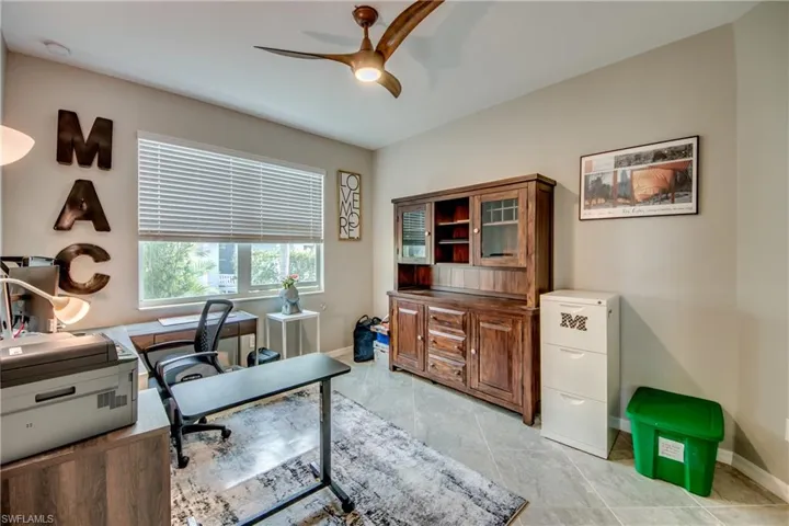 Home office featuring ceiling fan and light tile patterned floors