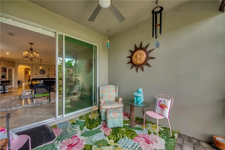 Sunroom / solarium with ceiling fan with notable chandelier