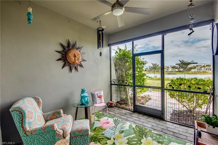 Sunroom featuring a water view and ceiling fan