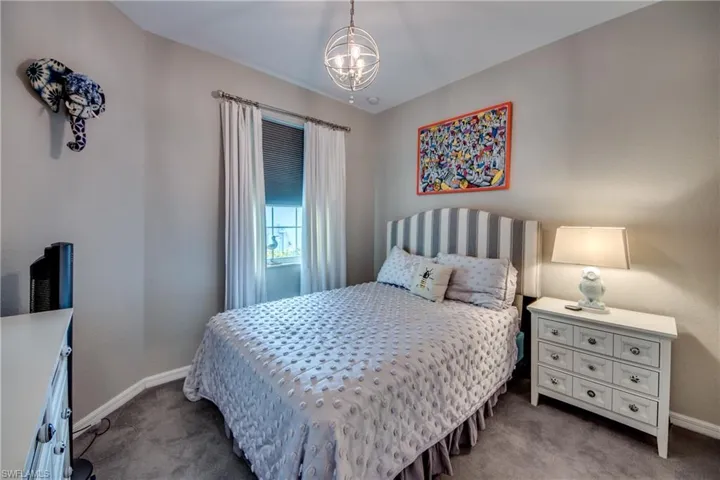 Bedroom featuring carpet flooring and a chandelier