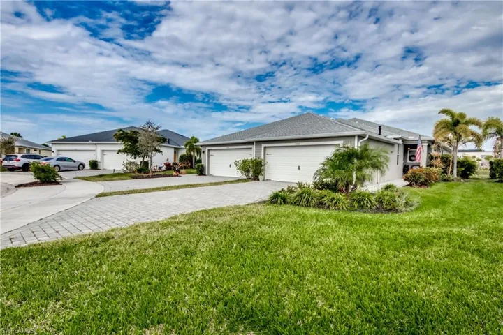 View of front of house featuring a garage and a front yard
