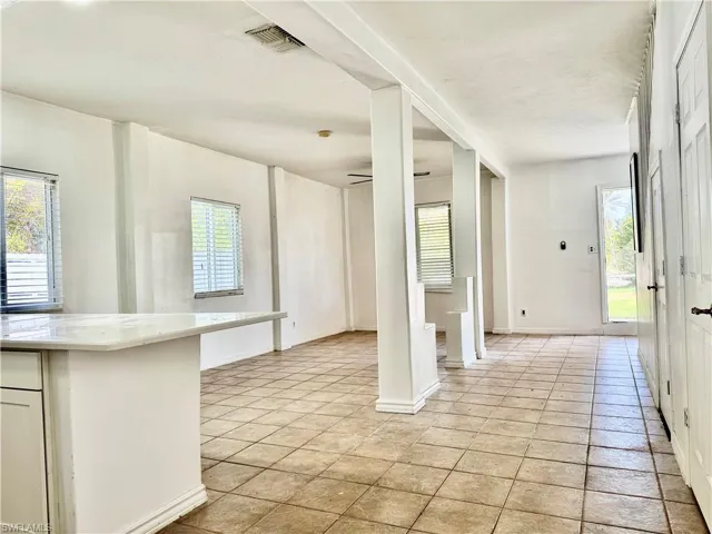Foyer with healthy amount of natural light and ceiling fan