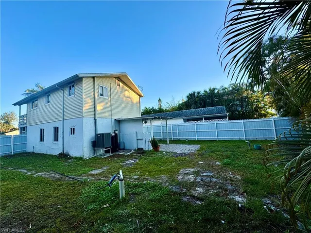 Rear view of property with a fenced backyard and stucco siding