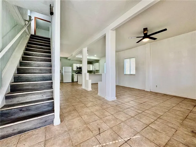 Stairway featuring a ceiling fan