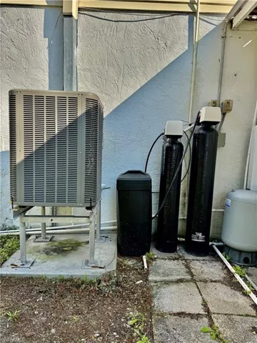 Exterior view of a water softener and stucco siding