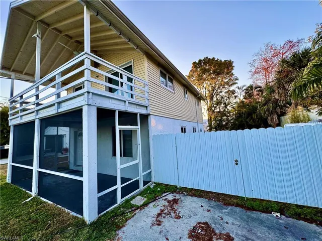View of home's exterior featuring a sunroom and a balcony