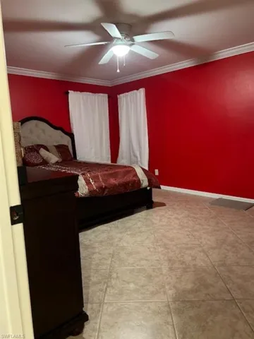 Bedroom featuring crown molding and ceiling fan