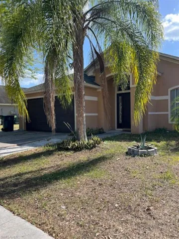 Obstructed view of property featuring stucco siding, concrete driveway, and an attached garage