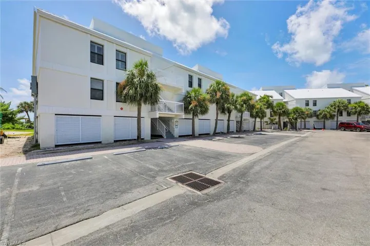 View of property featuring uncovered parking