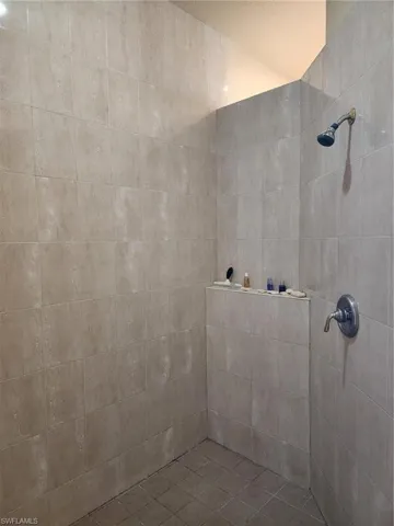 Full bathroom featuring tiled shower