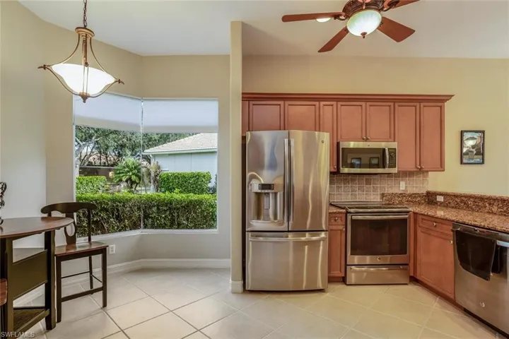 Kitchen Nook area with Seamless Glass Window, Stainless Steal Appliances