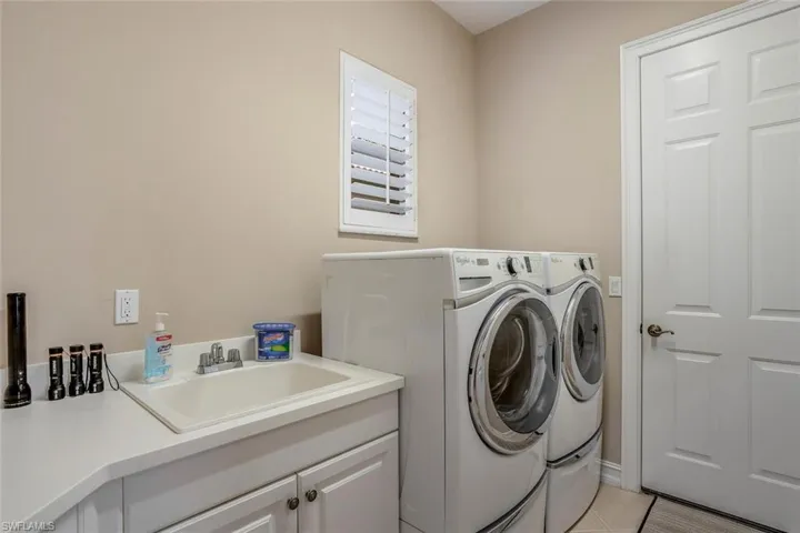 Laundry Room w/ Cabinetry and Sink