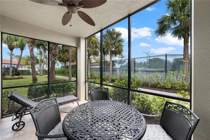 Sunroom / solarium featuring a ceiling fan and outdoor dining space