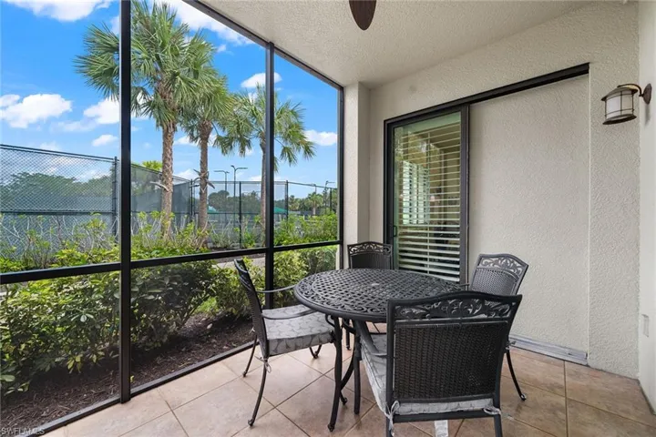 Sunroom featuring a ceiling fan and outdoor dining area