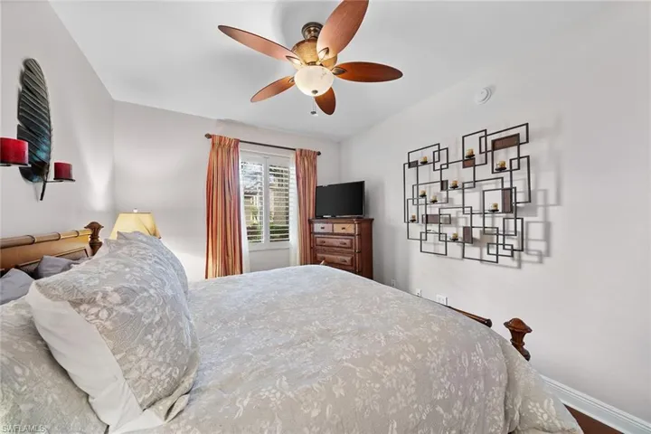 Bedroom featuring a ceiling fan and baseboards