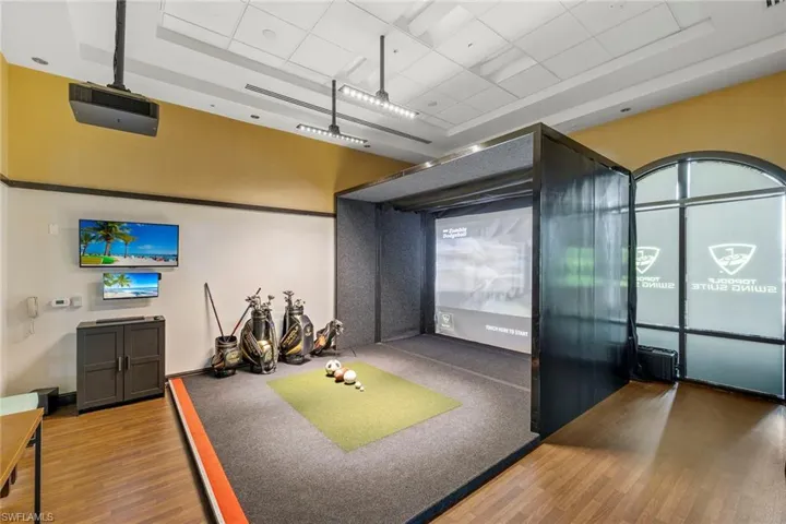 Playroom featuring golf simulator