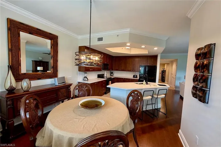 Dining room featuring ornamental molding, dark wood-style floors, and recessed lighting
