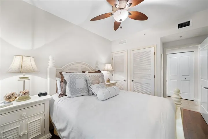 Bedroom featuring a closet, ceiling fan, wood finished floors, and vaulted ceiling