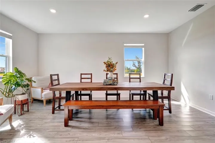 Dining space with light wood-type flooring and recessed lighting