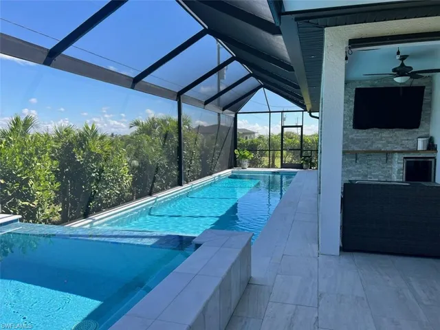 View of swimming pool with a sunroom, a patio, a lanai, and a pool with connected hot tub