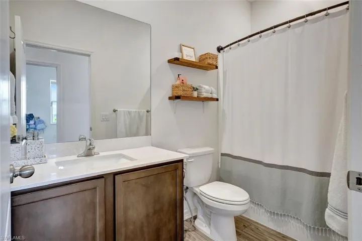 Full bath with vanity and light wood-type flooring