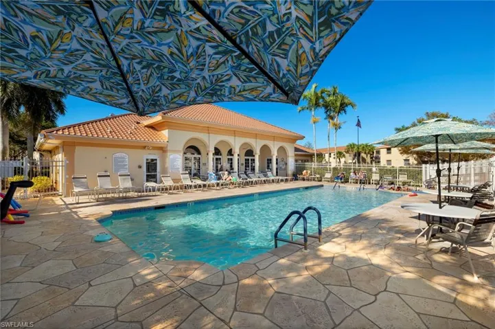 Pool featuring fence and a patio area