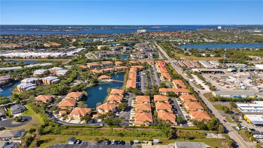 Birds eye view of property featuring a water view and a residential view