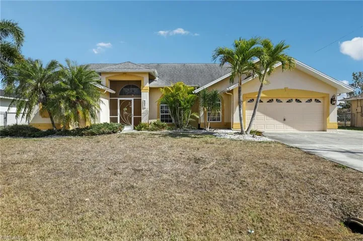 Ranch-style home featuring an attached garage, driveway, stucco siding, and a shingled roof
