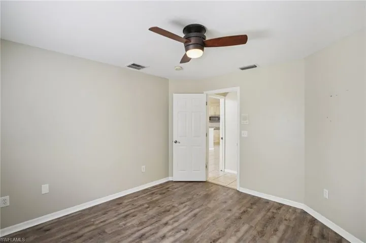 Spare room featuring wood finished floors and a ceiling fan