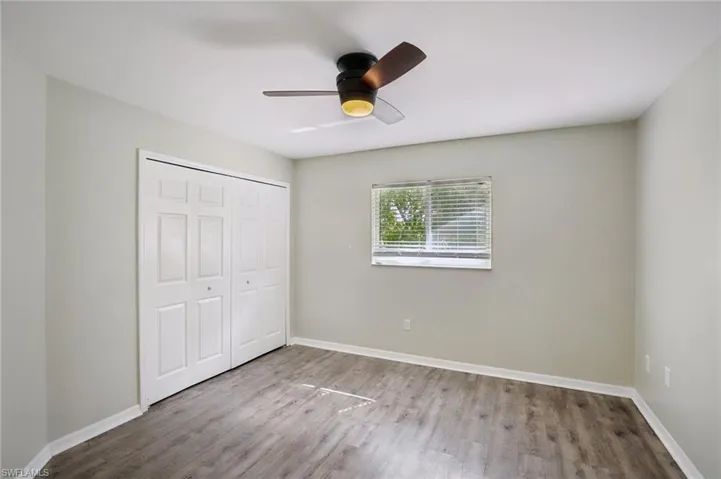 Unfurnished bedroom with a closet, ceiling fan, and light wood finished floors