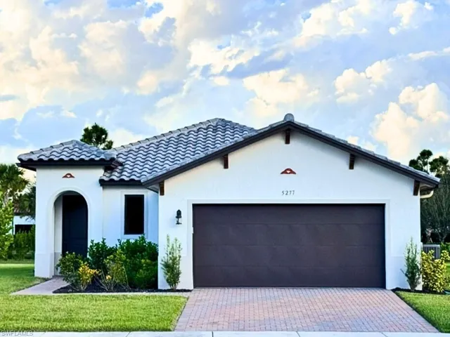 Modern spanish/metdierranean style stucco home with 2 car garage.