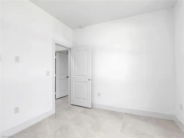 Unfurnished room with baseboards
