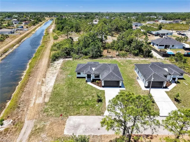 Drone / aerial view with a water view and a residential view